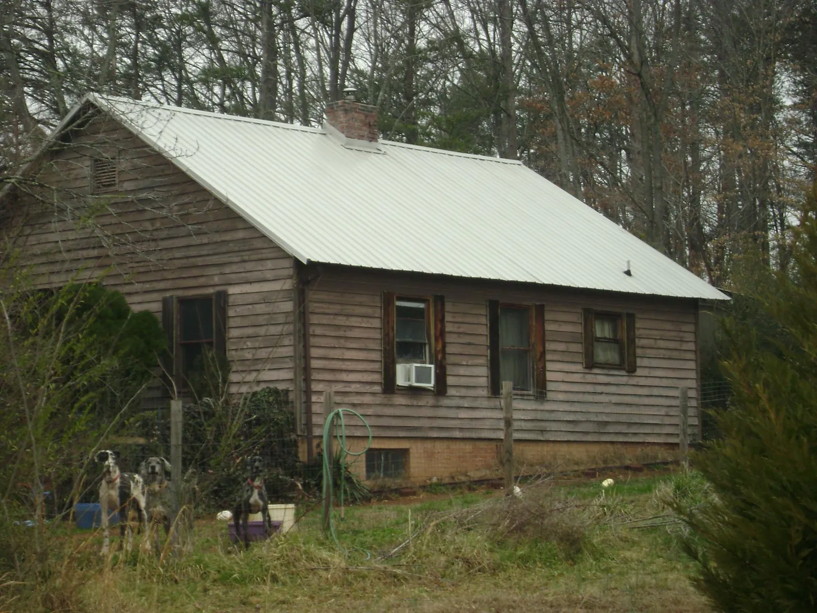 White metal roof on an old wood sided farmhouse, from a Metal Roof Installation job in Naytahwaush